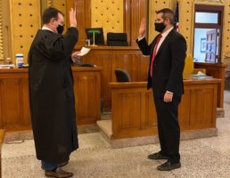 District Court Judge John Flynn delivers the Oath of Office to Matthew Speers, Boone County Attorney