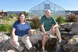 DMACC Horticulture instructor Diane Brockshus (left) and Horticulture Program Chair Jim Mason pose outside the Ankeny Campus Horticulture Greenhouse.